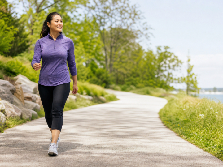 Adult walking outdoors on a clean bright path for everyday fitness